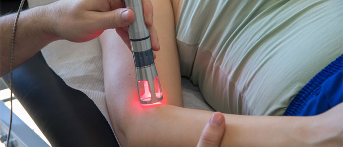 chiropractic patient receiving cold laser therapy treatment